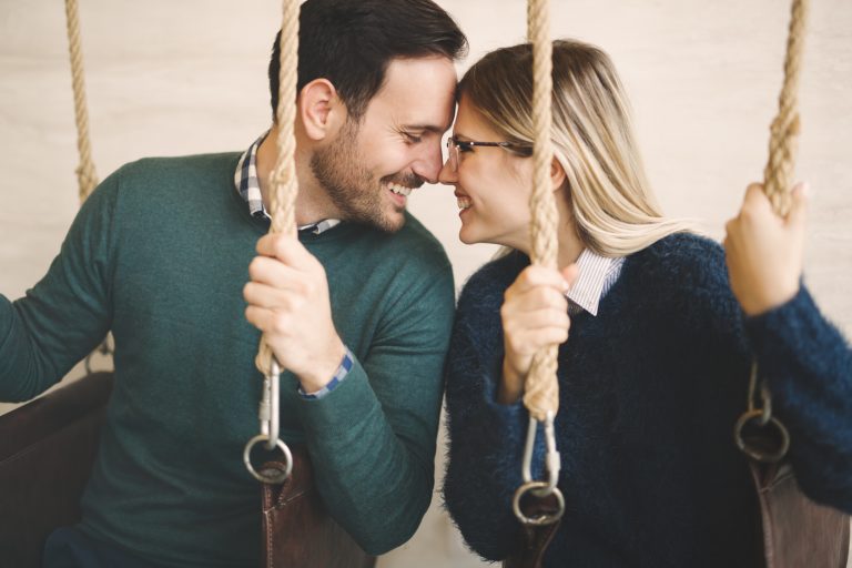 Beautiful couple bonding while in swing